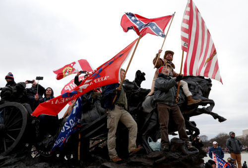 Pro-Trump protesters wave banners during clashes with Capitol police during the certification of the 2020 U.S. presidential election results by the U.S. Congress, Washington, D.C., U.S., Jan. 6, 2021