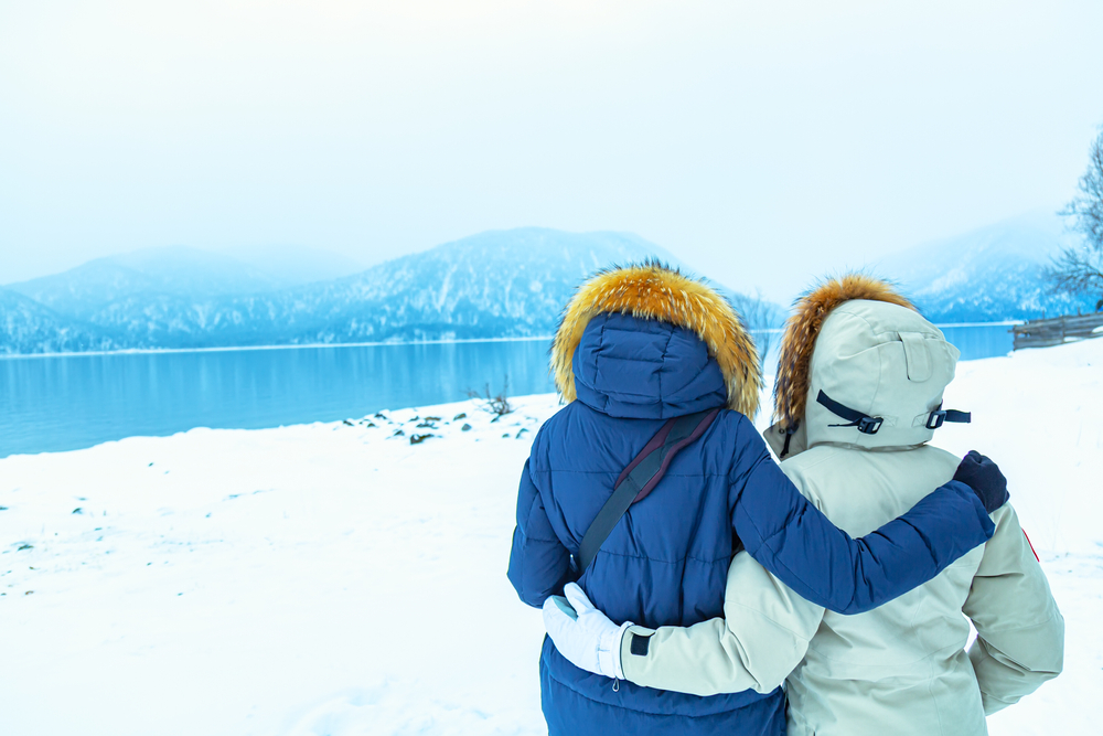 Two Norwegian women embrace after hiking to a secluded spot