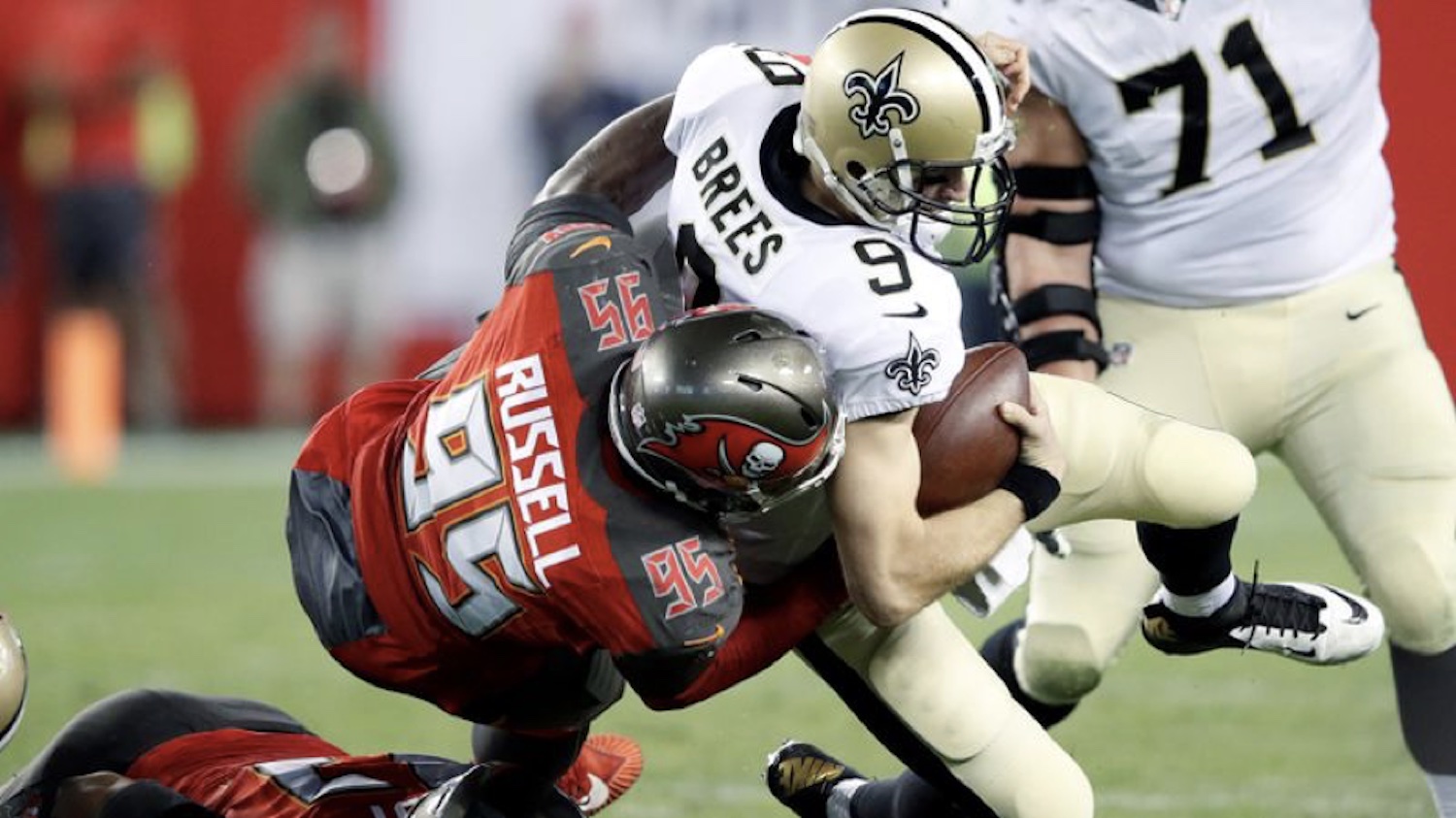 Russell (left) tackles New Orleans Saints quarterback Drew Brees in 2017. Photo: Associated Press