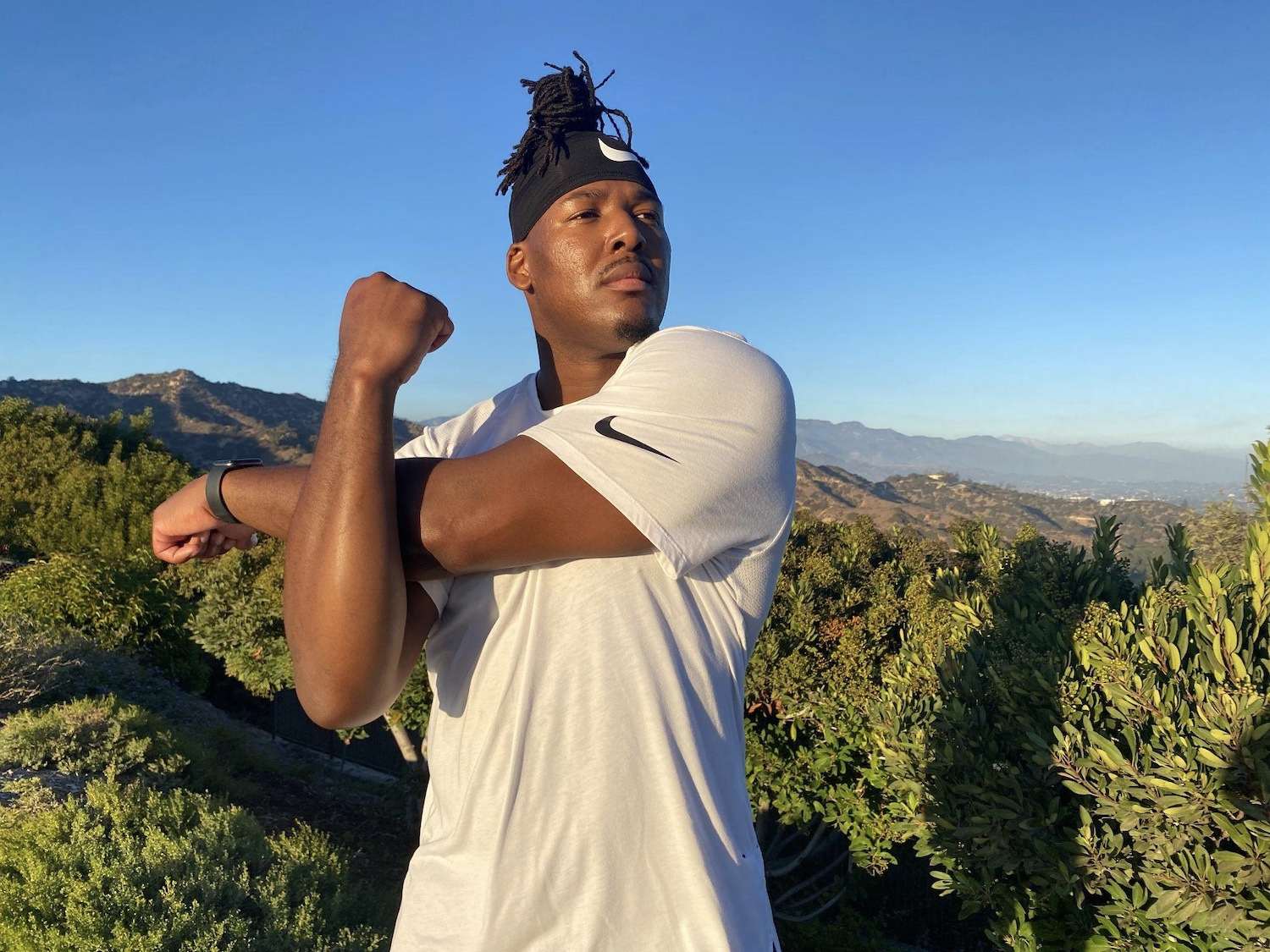 Russell stretches for a workout at Griffith Park Observatory in Los Angeles, a place he says inspires his artistic side. Photo: Mike Ciriaco for LGBTQ Nation