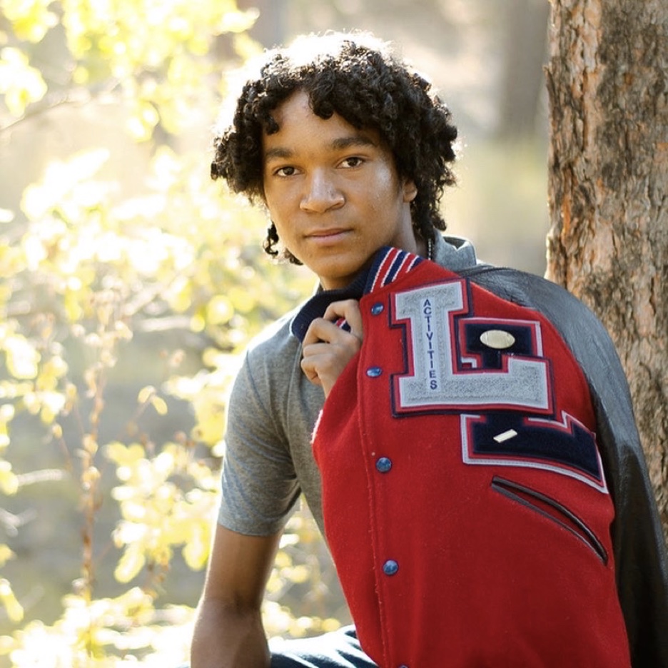 Marc in Colorado Springs with his varsity football letter jacket.