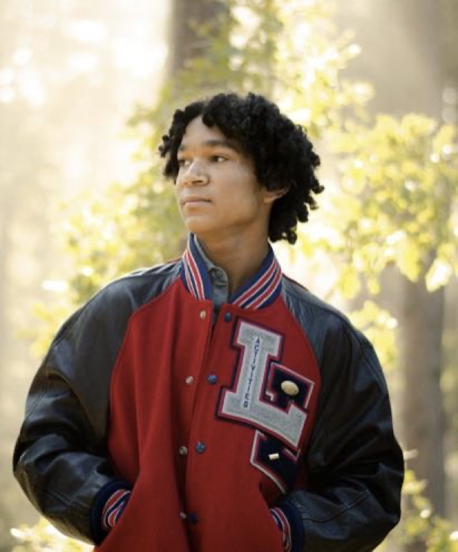 Marc wearing his dad’s football letter jacket with his own letter sewn on.