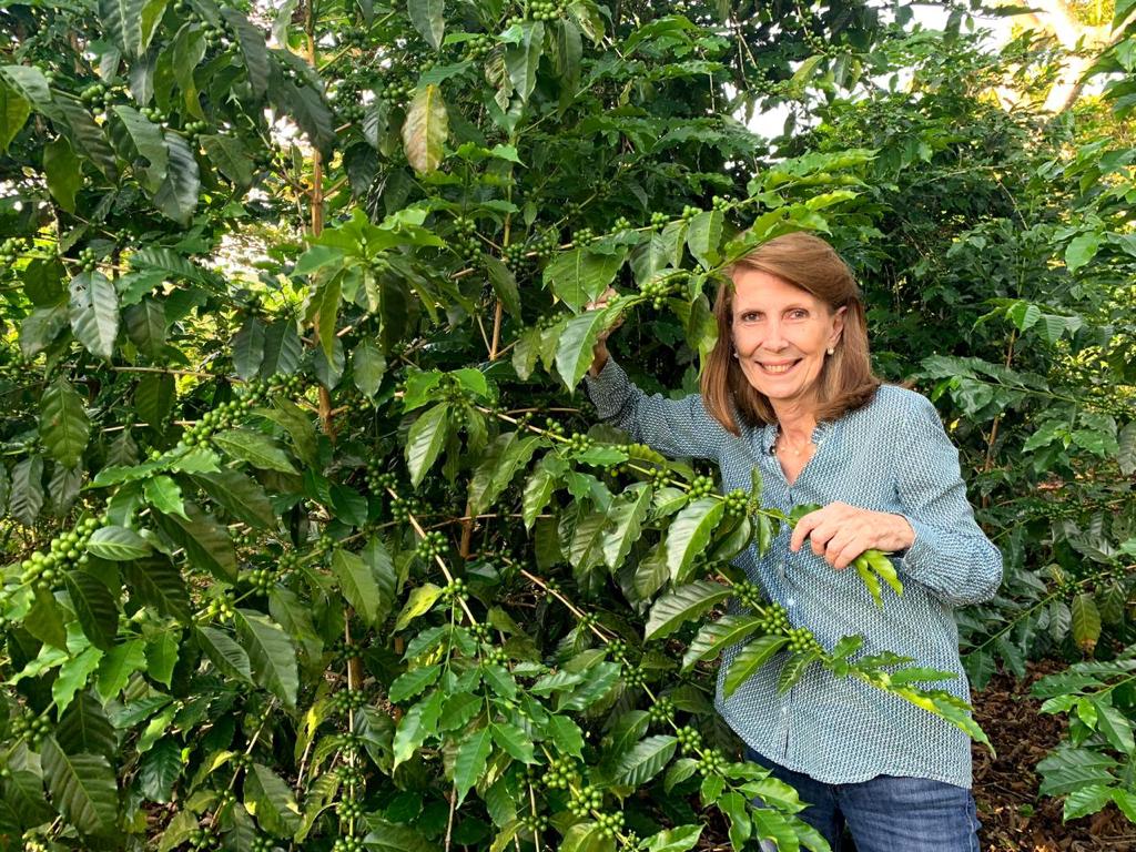 Carmen Da Silva poses with her coffee shrubs