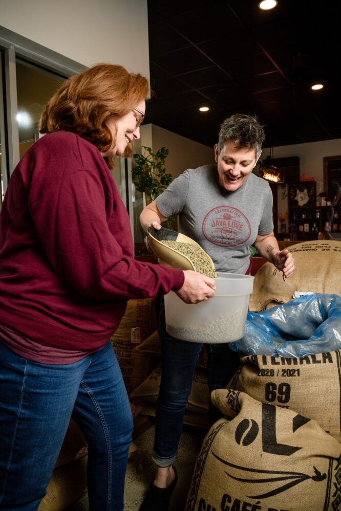 Jodie Dawson and Kristine Petrik prepare green coffee beans for roasting at Java Love Roasters