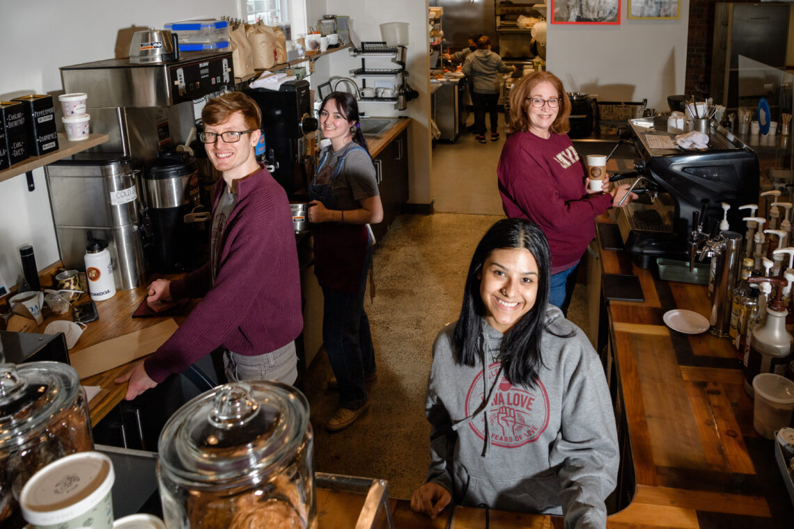 Jodie Dawson works with baristas behind the counter at Java Love Roasters