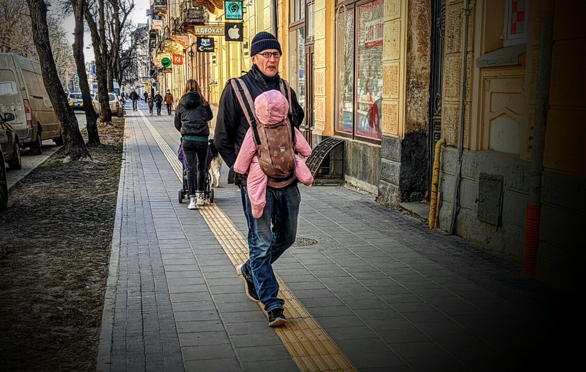 3/22/22: A man carrying his daughter on the streets of Lviv. 