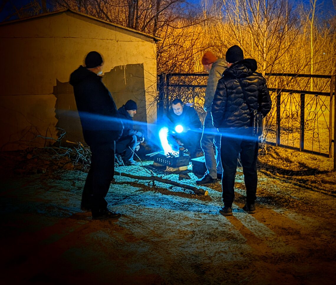 3/19/22: A neighborhood patrol group grills fish outside during their shift in Lviv.