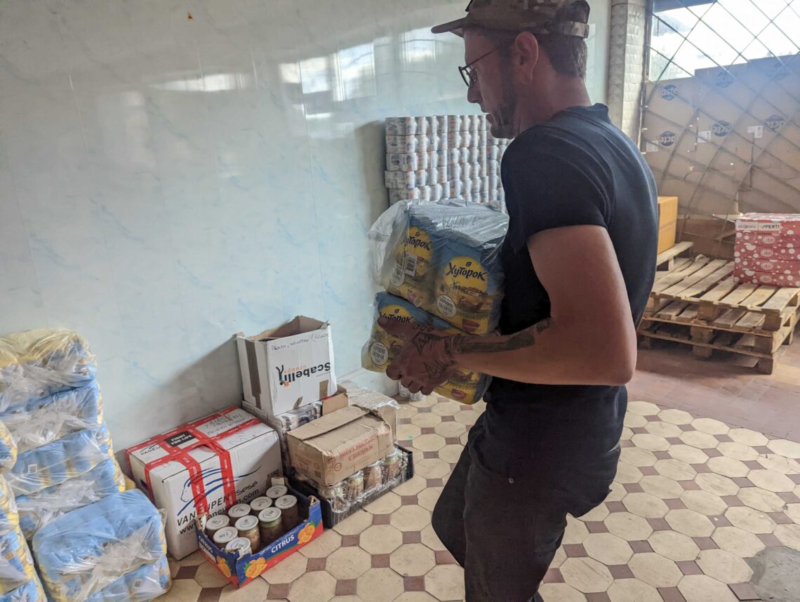 Agatha Williams carrying supplies in Parkhomivka.