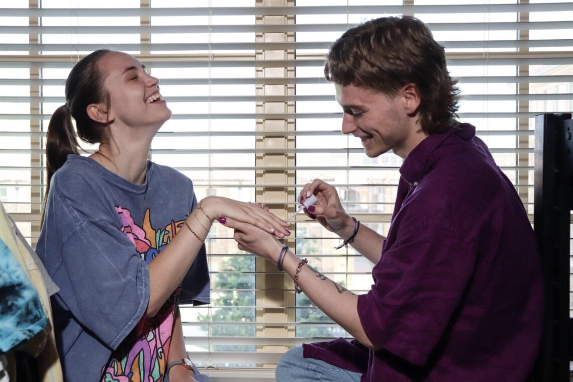 Trevor hanging out with his friend, Maryna Summers, in his dorm room. Photo by Topher Covarrubio for LGBTQ Nation