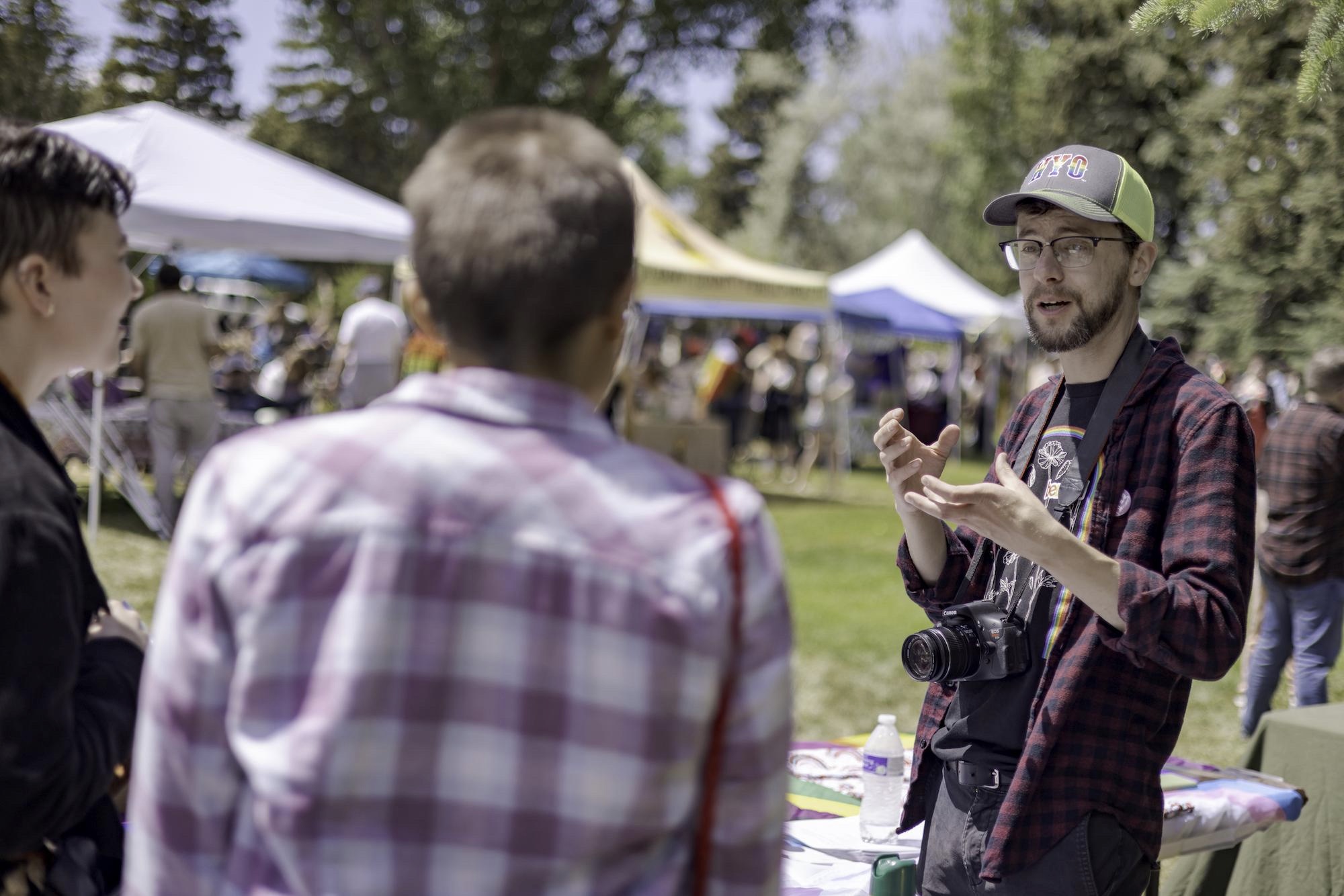 Daniel Galbreath chats with Pride in the Park attendees in Washington Park, Laramie, Wyoming. Photo by Kyle Spradley Photography for LGBTQ Nation