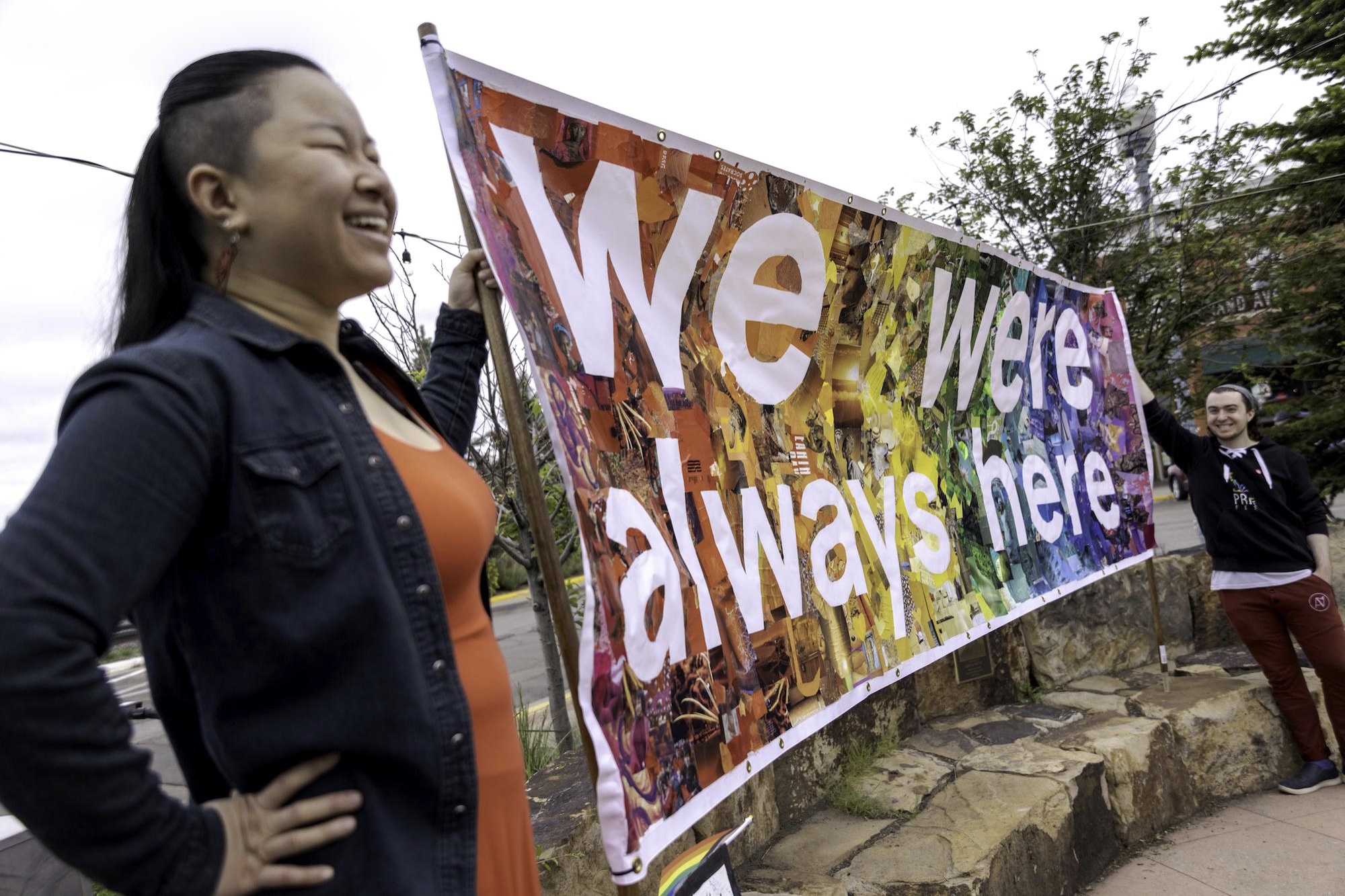 Volunteers Zanna Wright, left, and Kevin Rossi hold a banner at Laramie PrideFest’s proclamation reading at First Street Plaza in Laramie, Wyoming, on June 25, 2022. Photo by Kyle Spradley Photography for LGBTQ Nation 