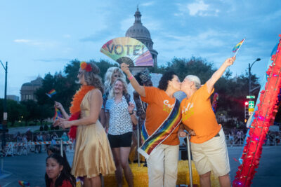 Celia Israel and her wife, Celinda Garza, kiss during Pride 