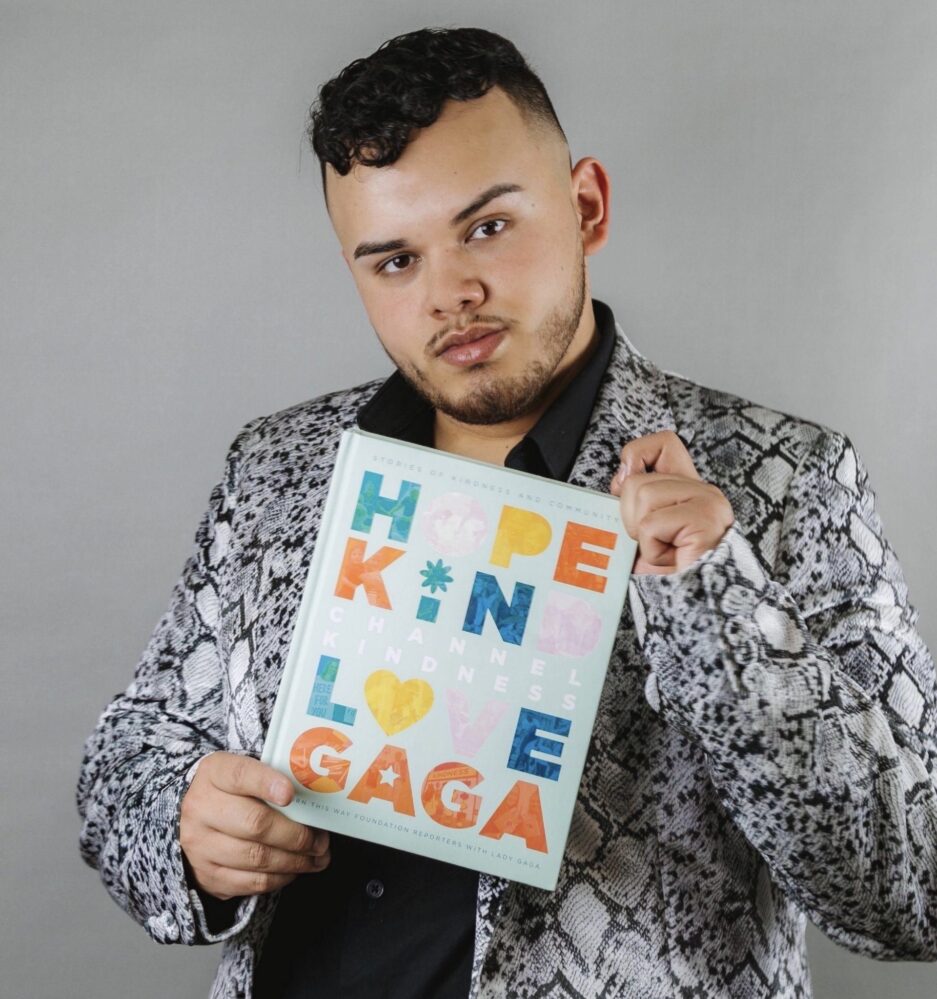 Juan Acosta holds a copy of Channel Kindness, a book project he collaborated on with Lady Gaga. Photo by Irma Hernandez.