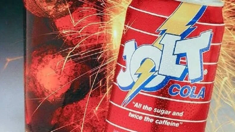 an ad for Jolt Cola with lightning behind the can